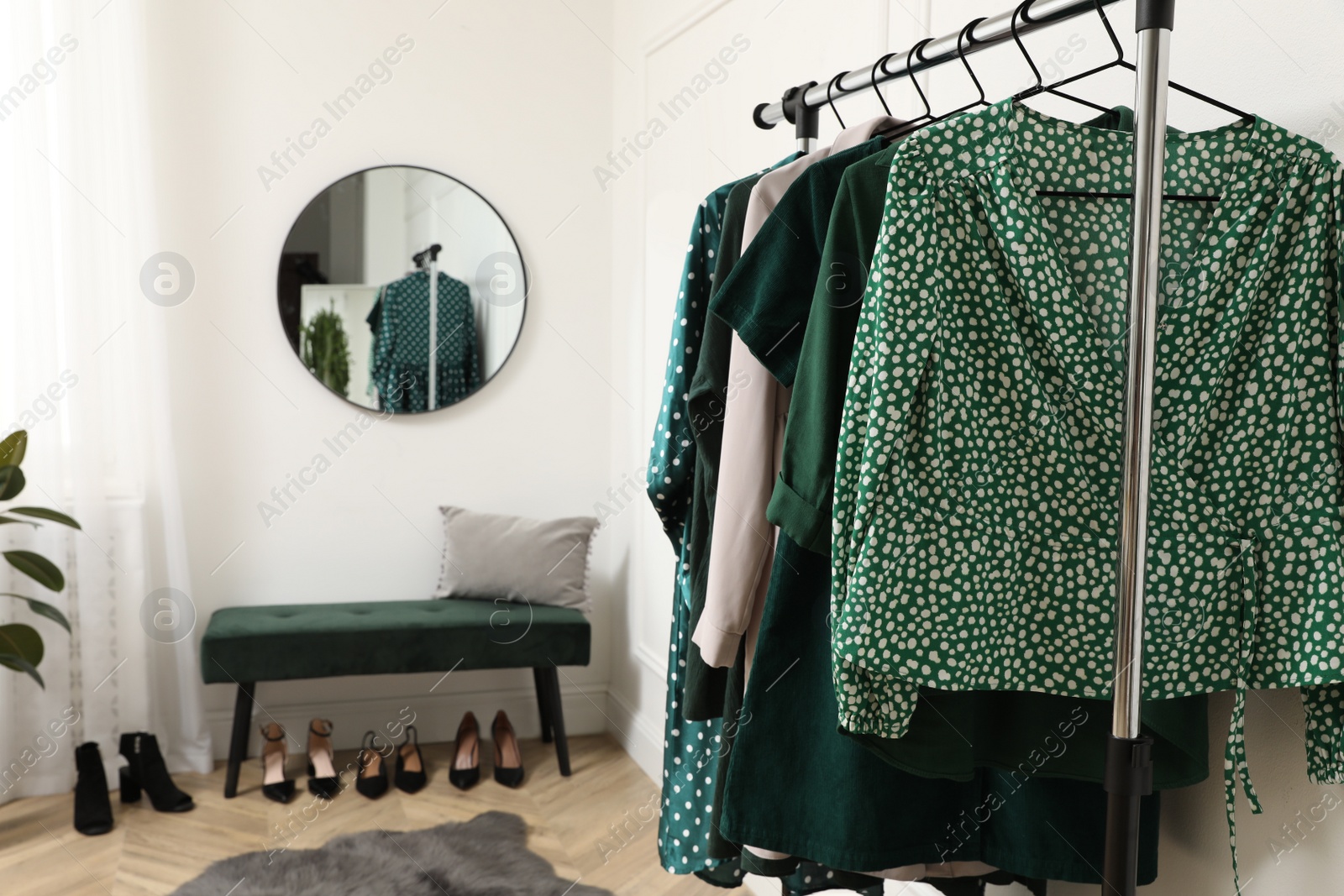 Photo of Modern room with clothes rack and mirror. Interior design