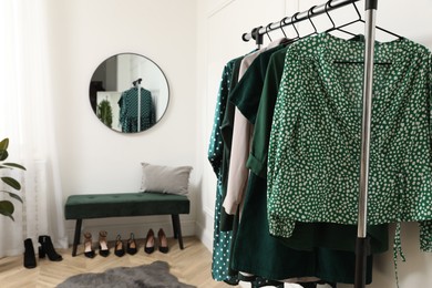 Photo of Modern room with clothes rack and mirror. Interior design