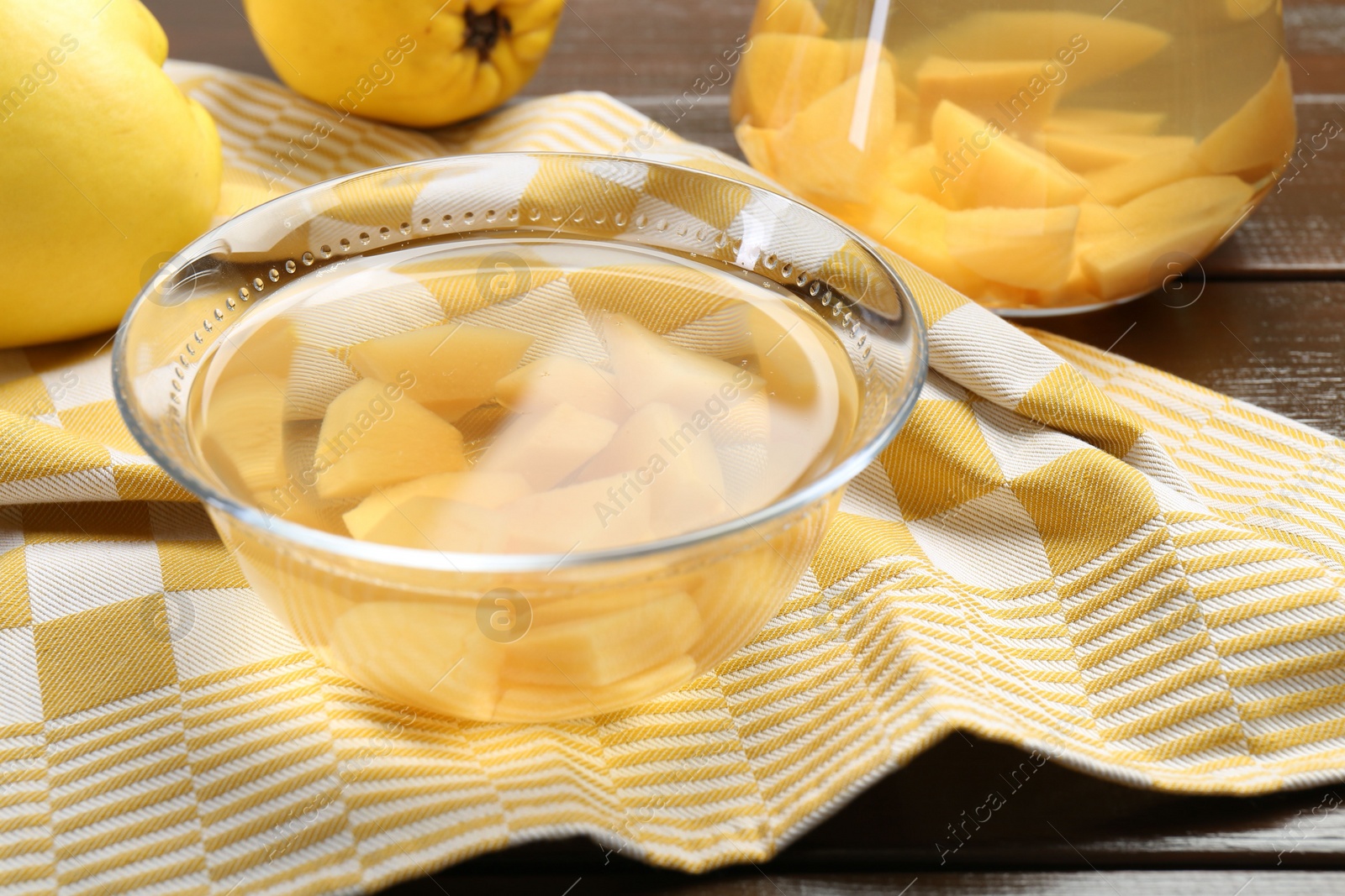 Photo of Delicious quince drink and fresh fruits on wooden table, closeup