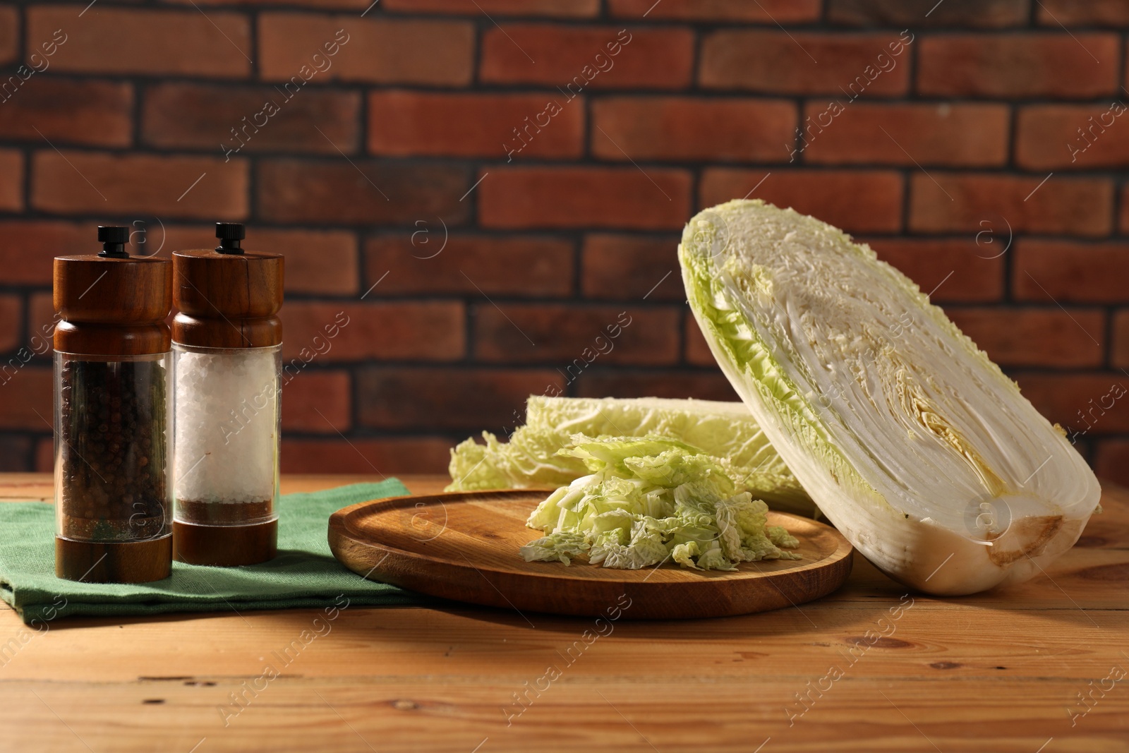 Photo of Fresh Chinese cabbage and spices on wooden table