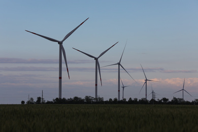 Beautiful view of landscape with wind turbines in evening. Alternative energy source