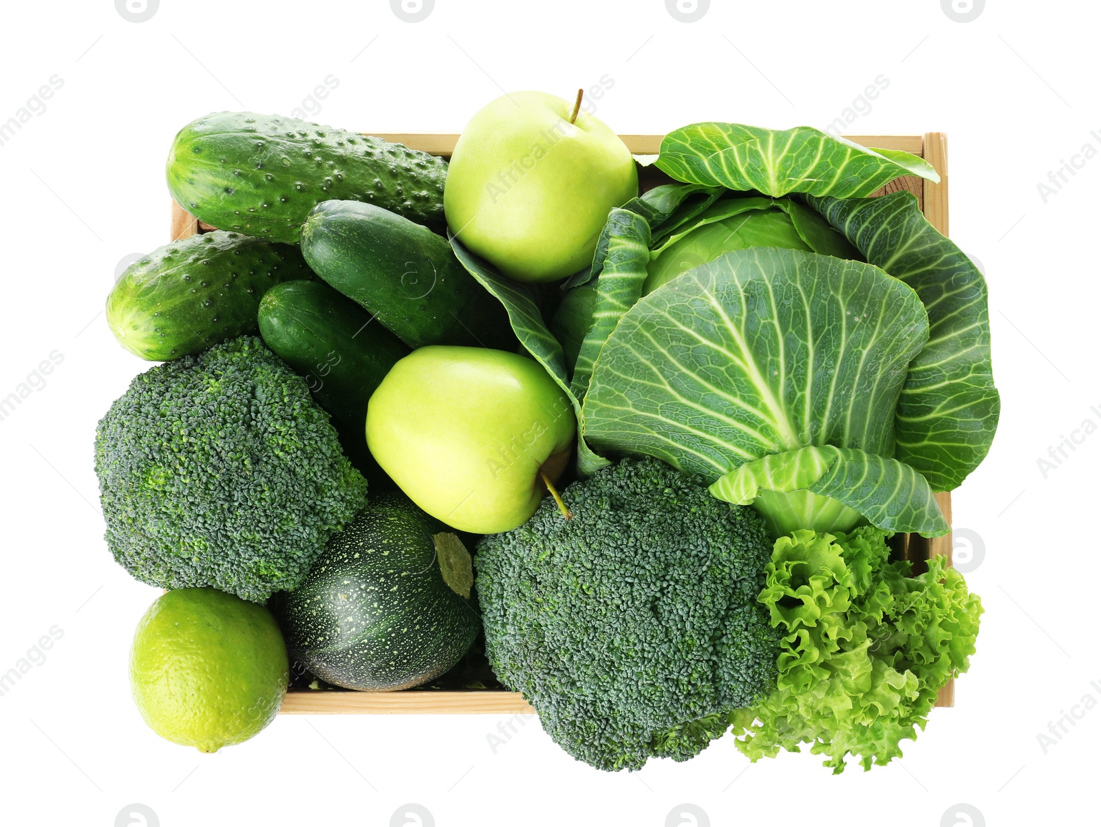 Photo of Wooden crate full of fresh green fruits and vegetables on white background, top view