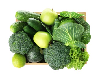 Wooden crate full of fresh green fruits and vegetables on white background, top view