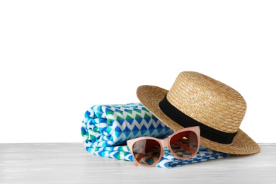 Set of beach accessories on table against white background. Space for text