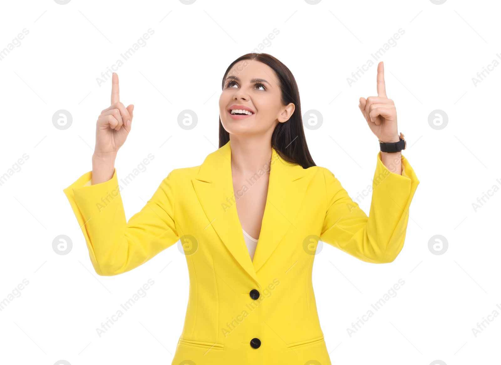 Photo of Beautiful happy businesswoman in yellow suit pointing at something on white background