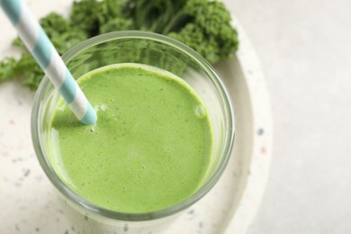 Photo of Tasty kale smoothie on light grey table, closeup