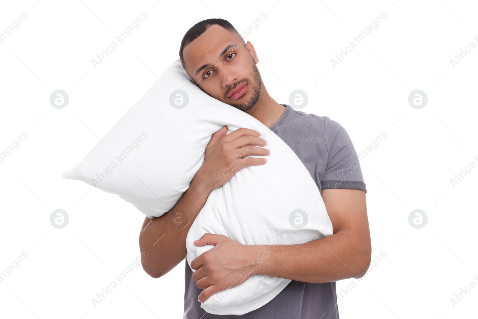 Photo of Tired man with pillow on white background. Insomnia problem