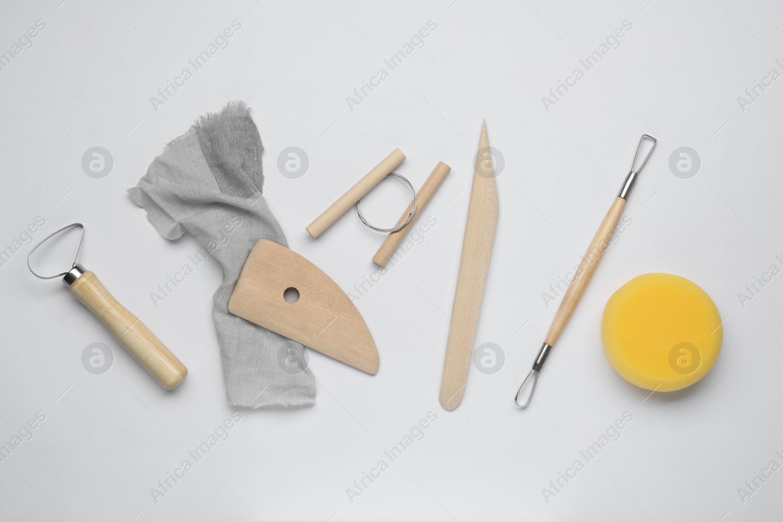 Photo of Set of clay modeling tools on white background, flat lay