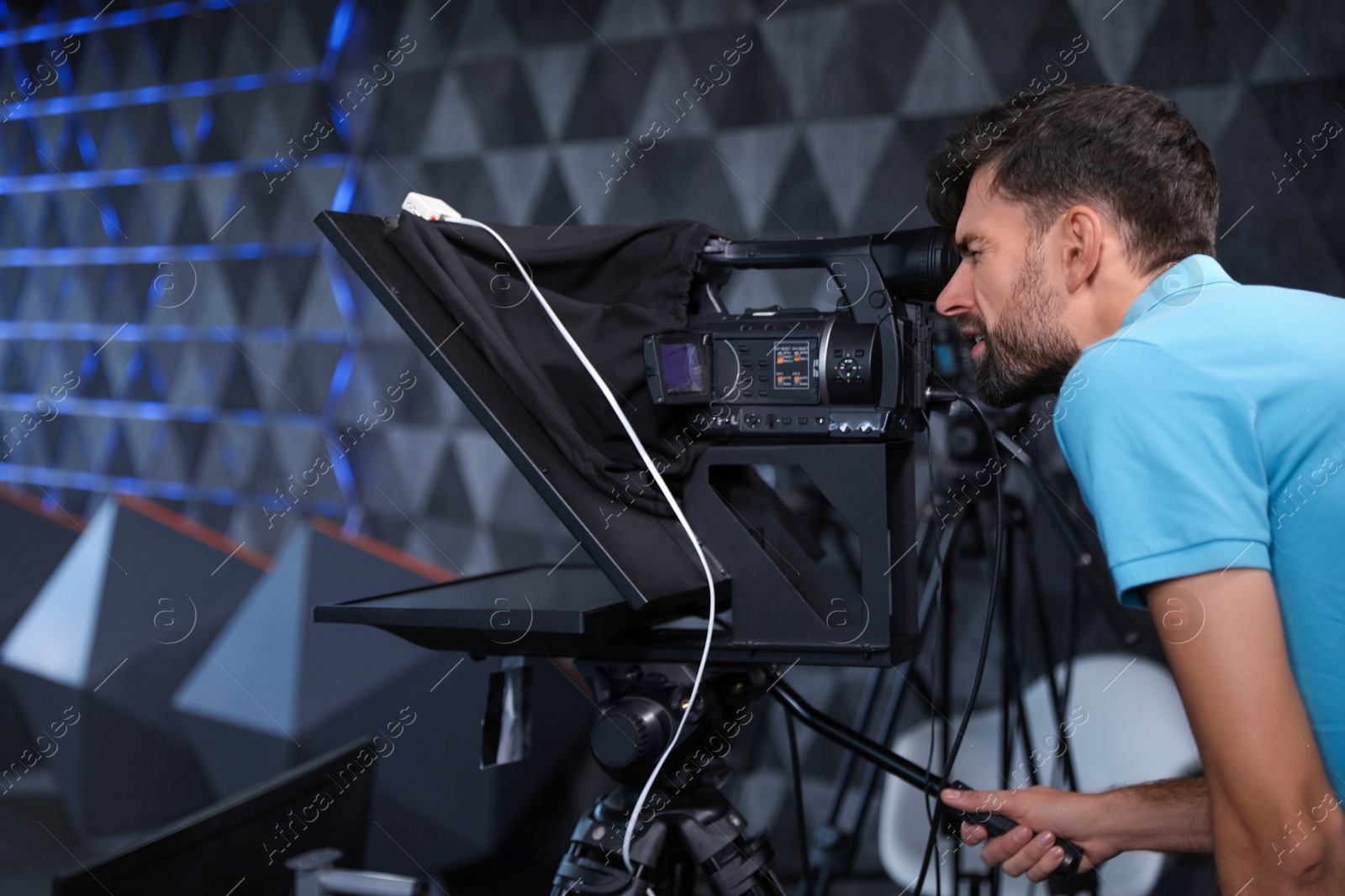 Photo of Professional video camera operator working in studio