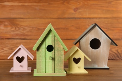 Beautiful colorful bird houses on wooden table