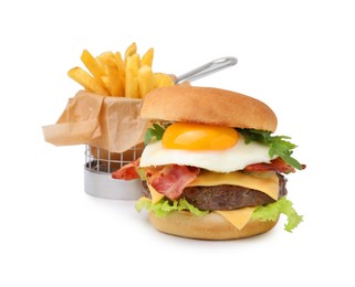 Photo of Delicious burger with fried egg and french fries isolated on white