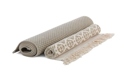 Different rolled carpets on white background. Interior element