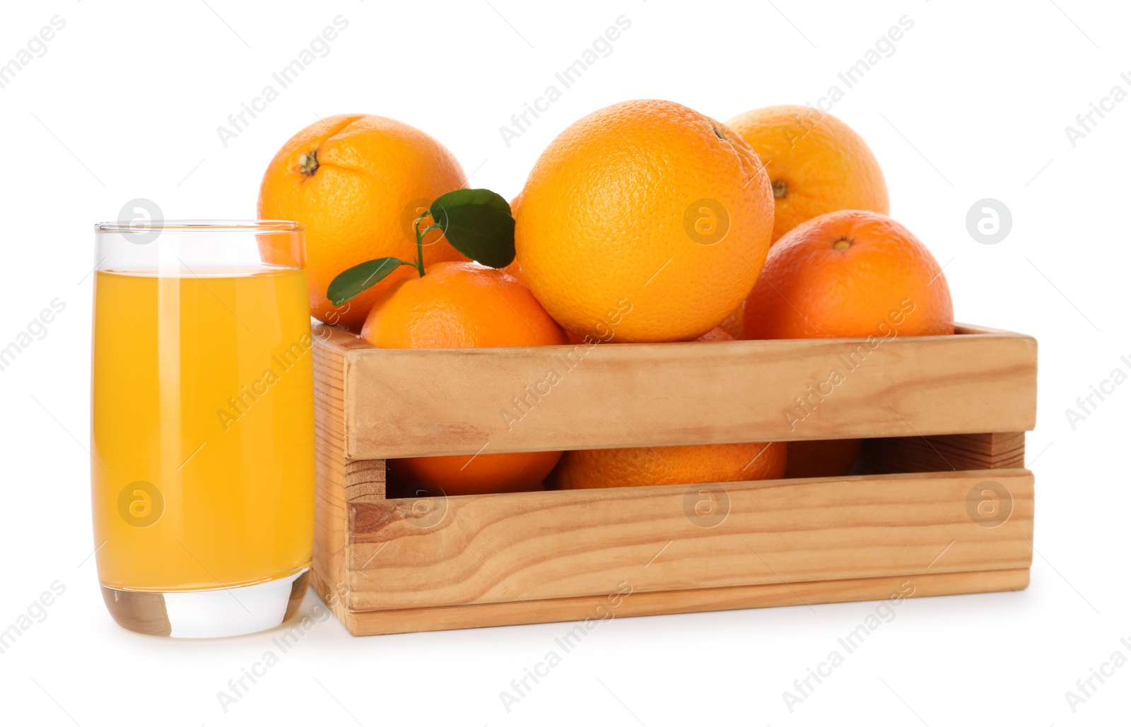 Photo of Fresh oranges in wooden crate and glass of juice isolated on white