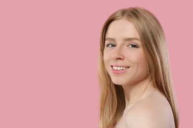 Photo of Portrait of beautiful young woman on pink background. Space for text