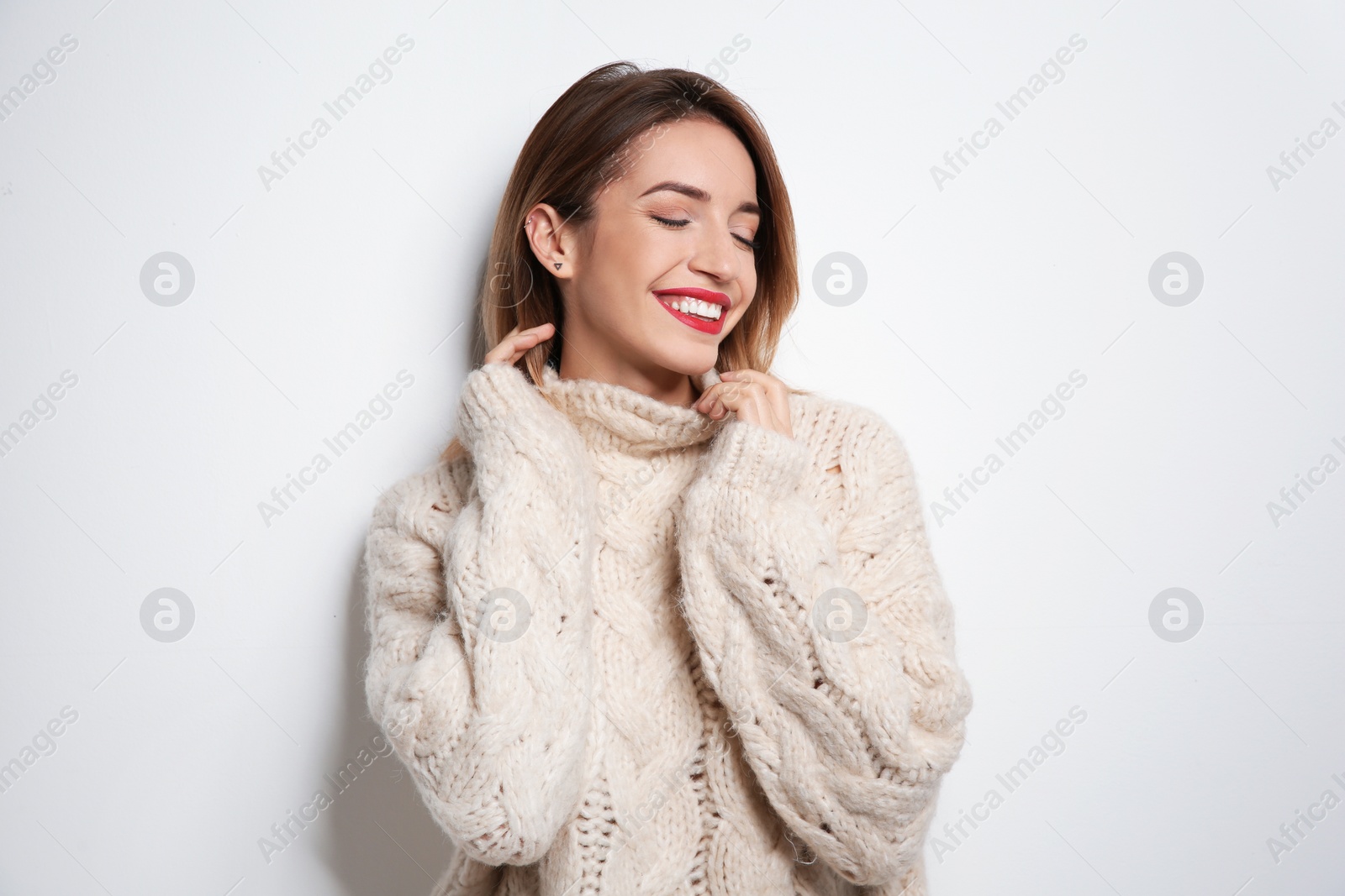 Photo of Beautiful young woman in warm sweater on white background