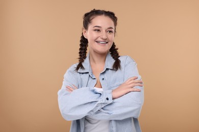 Smiling woman with braces on beige background