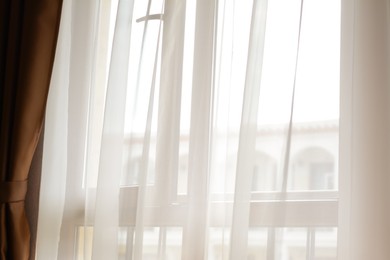 Window behind white curtain indoors in morning