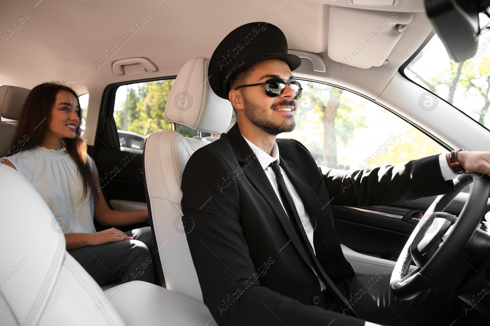 Photo of Young businesswoman with handsome driver in luxury car
