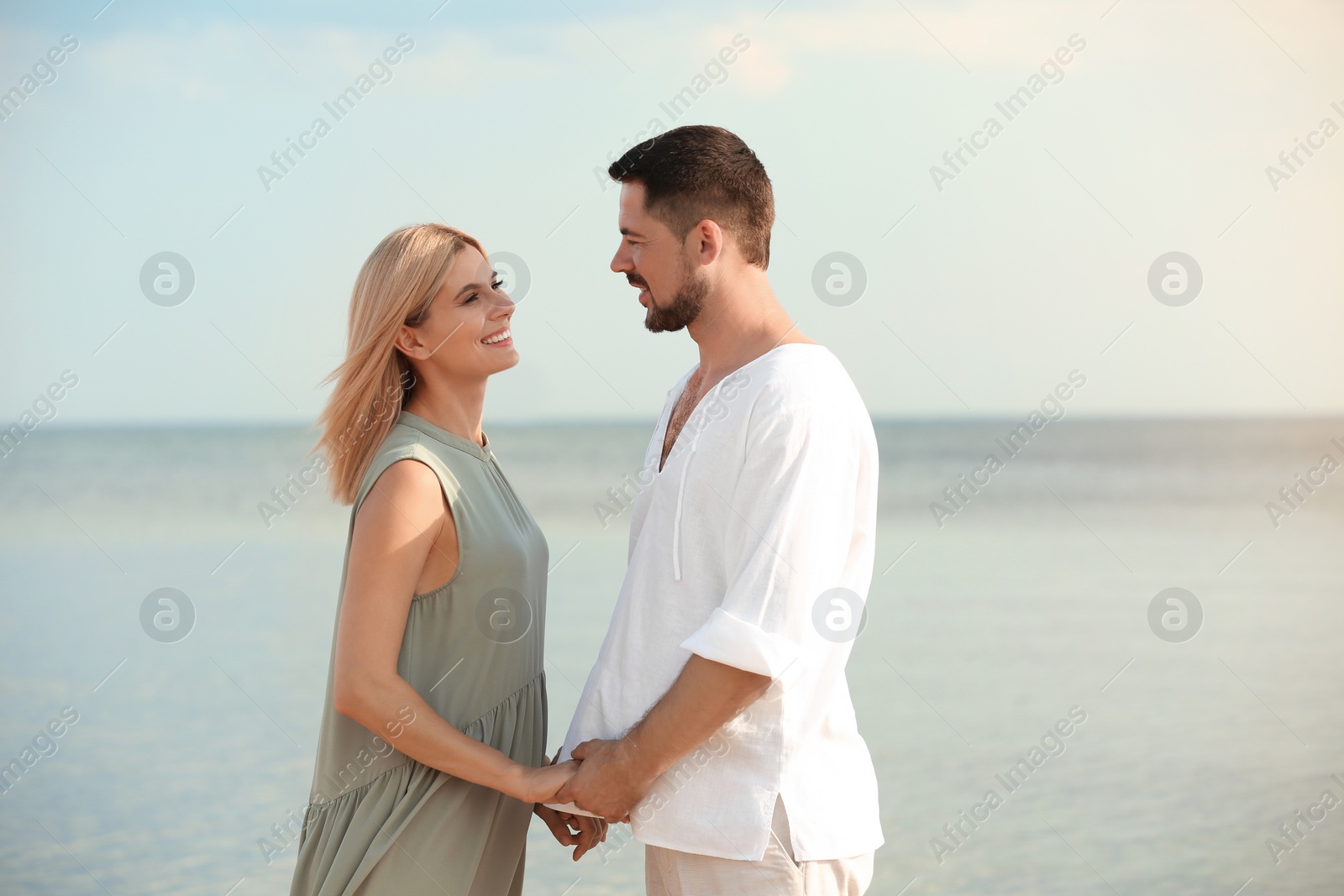 Photo of Happy romantic couple spending time together on beach