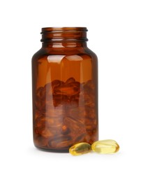 Photo of Jar and vitamin capsules isolated on white