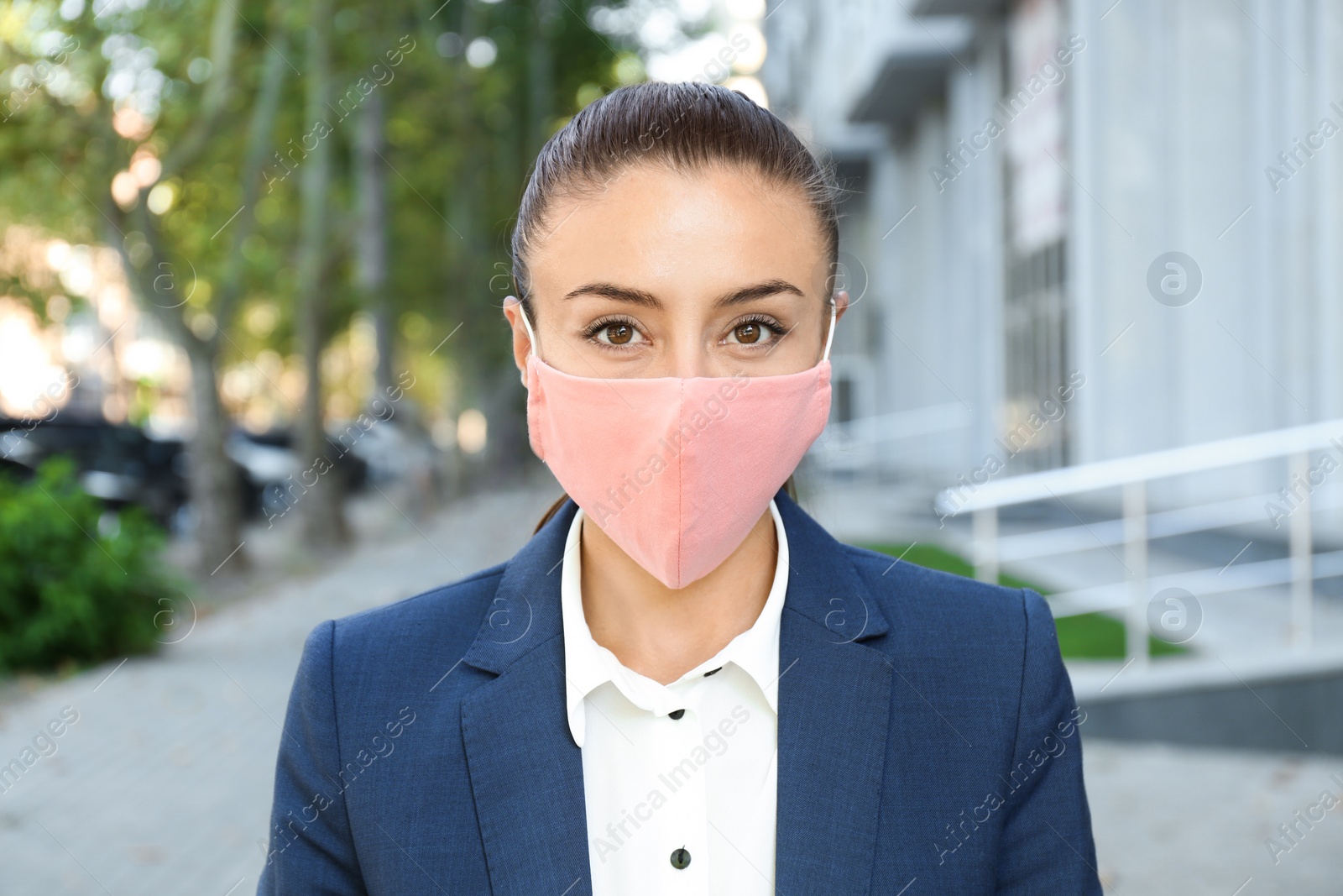 Photo of Woman wearing handmade cloth mask outdoors. Personal protective equipment during COVID-19 pandemic