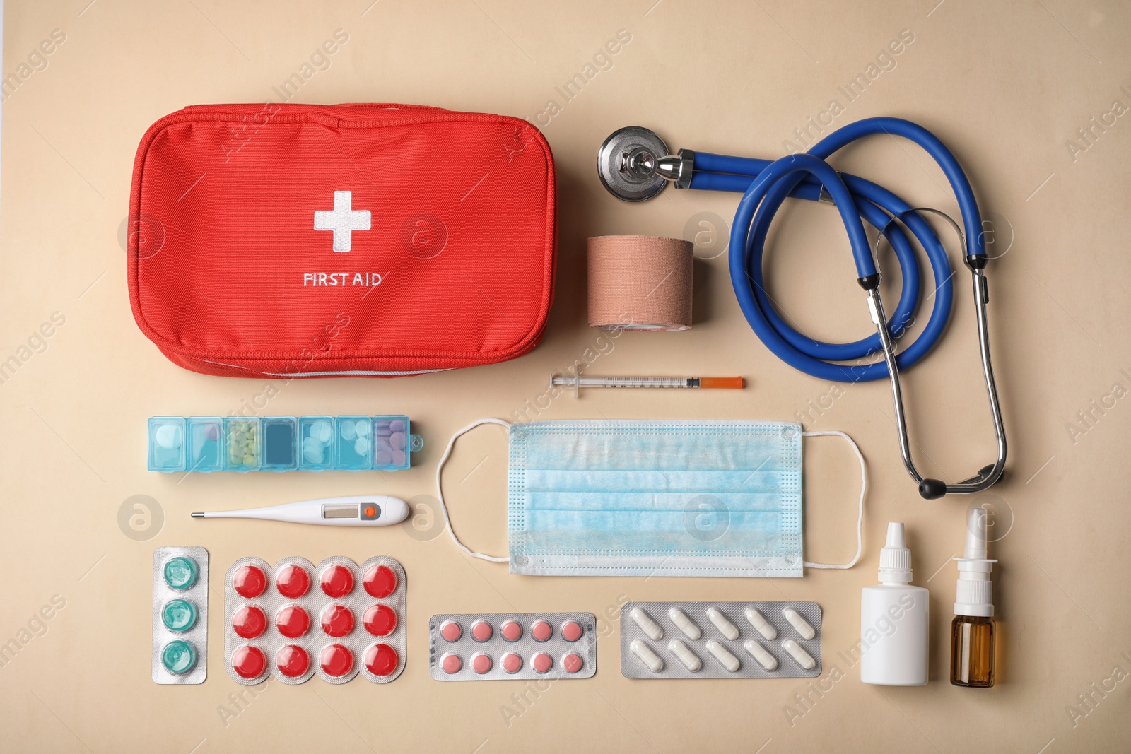 Photo of Flat lay composition with first aid kit on color background