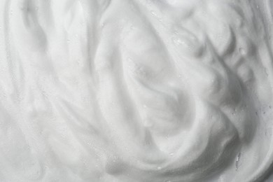 Photo of Foam as background, closeup. Face cleanser, skin care cosmetic