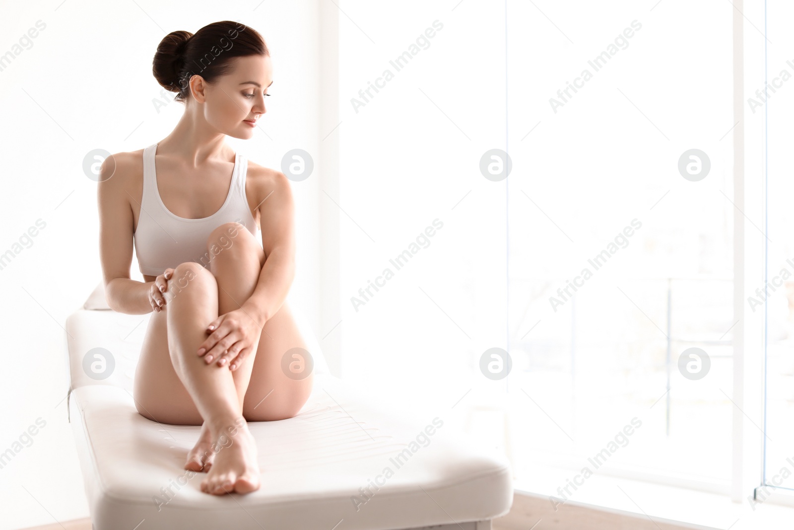 Photo of Young woman showing smooth silky skin after epilation at home