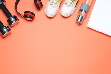 Photo of Flat lay composition with sport items on coral background, space for text