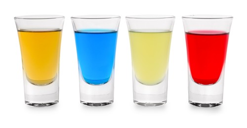 Photo of Different shooters in shot glasses isolated on white. Alcohol drink