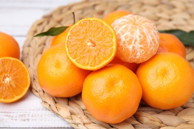 Fresh juicy tangerines on white wooden table