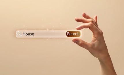 Image of House hunting. Woman holding virtual search bar on beige background, closeup. Banner design