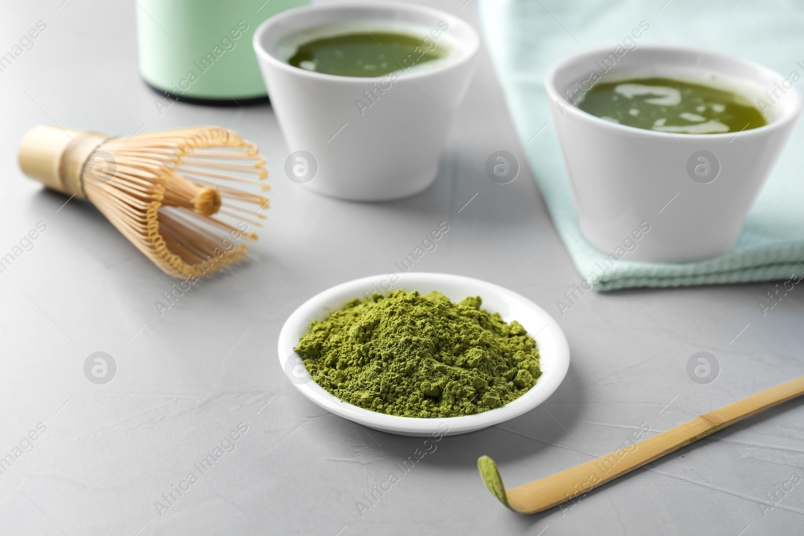 Photo of Plate with powdered matcha tea and chashaku on table