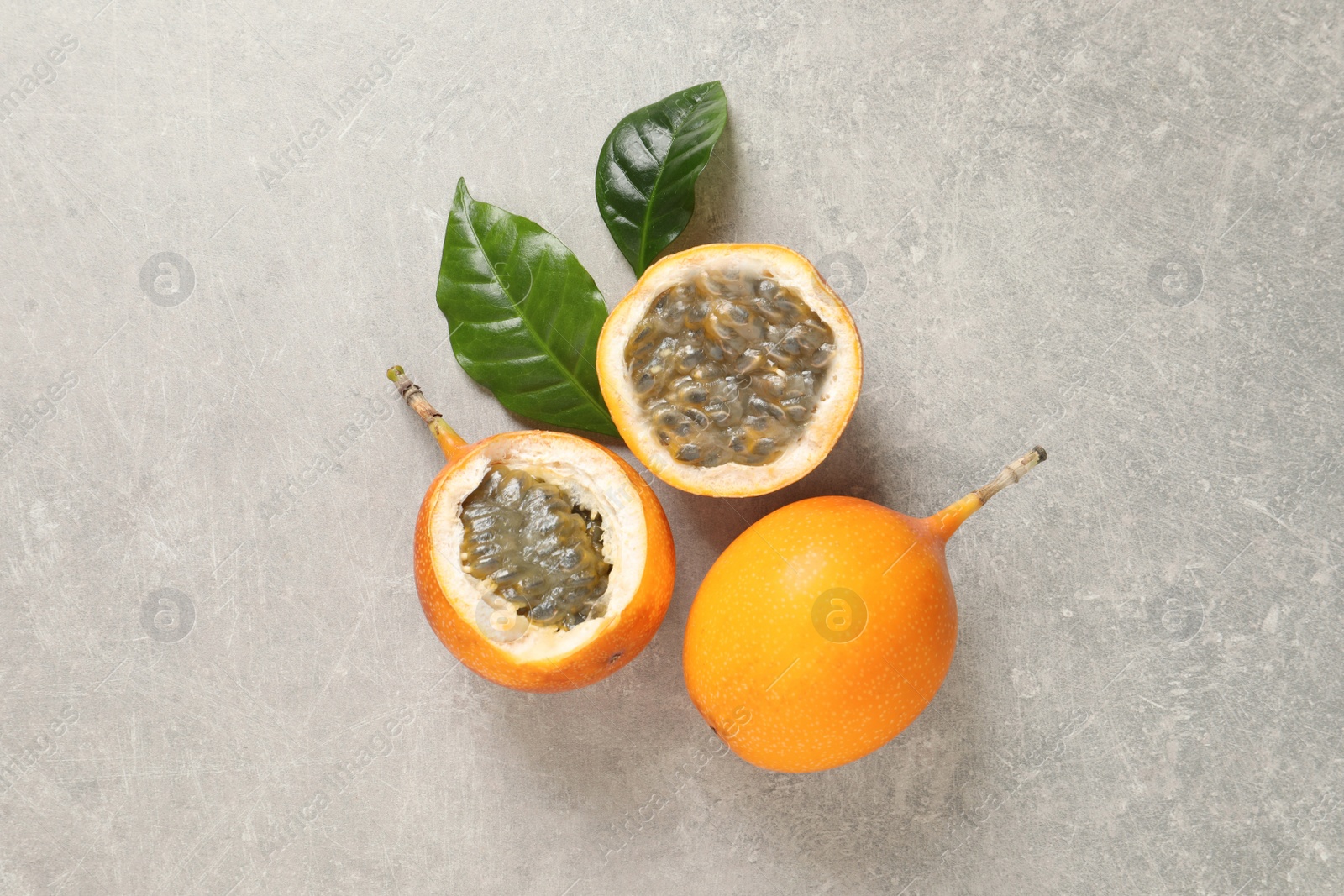 Photo of Delicious ripe granadillas on light table, flat lay