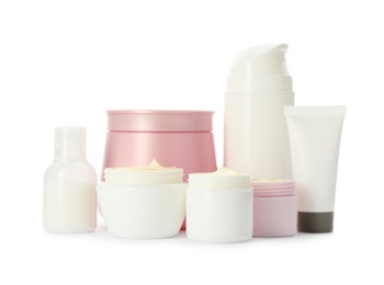 Photo of Different containers with hand cream and other cosmetic on white background