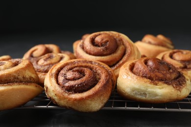 Photo of Tasty cinnamon rolls on table, closeup view