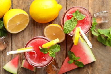 Delicious fresh watermelon drink on wooden table, flat lay