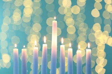 Photo of Hanukkah celebration. Burning candles against blurred lights