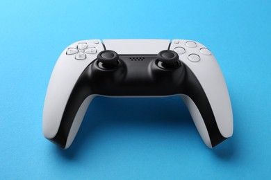 Photo of Wireless game controller on light blue background