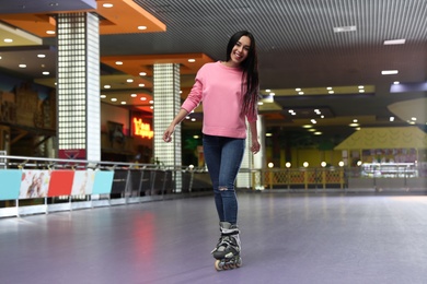 Photo of Young woman spending time at roller skating rink