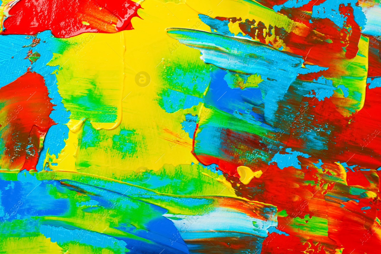 Photo of Closeup view of artist's palette with mixed bright paints as background