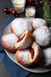 Delicious sweet buns with jam and decor on table
