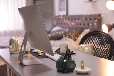 Photo of Stylish workplace interior with modern computer on desk