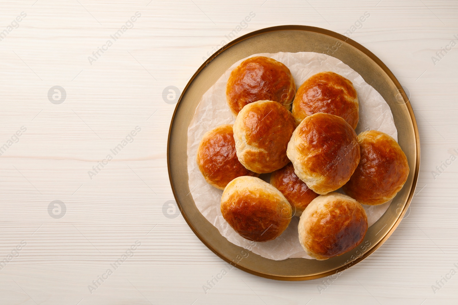 Photo of Plate with freshly baked soda water scones on white wooden table, top view. Space for text