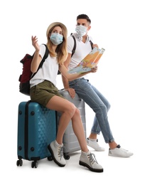 Photo of Couple in face masks with map on white background. Summer travel
