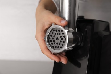 Woman assembling electric meat grinder, closeup view