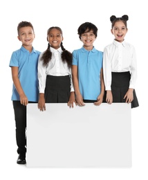 Photo of Happy children in school uniform with blank board on white background