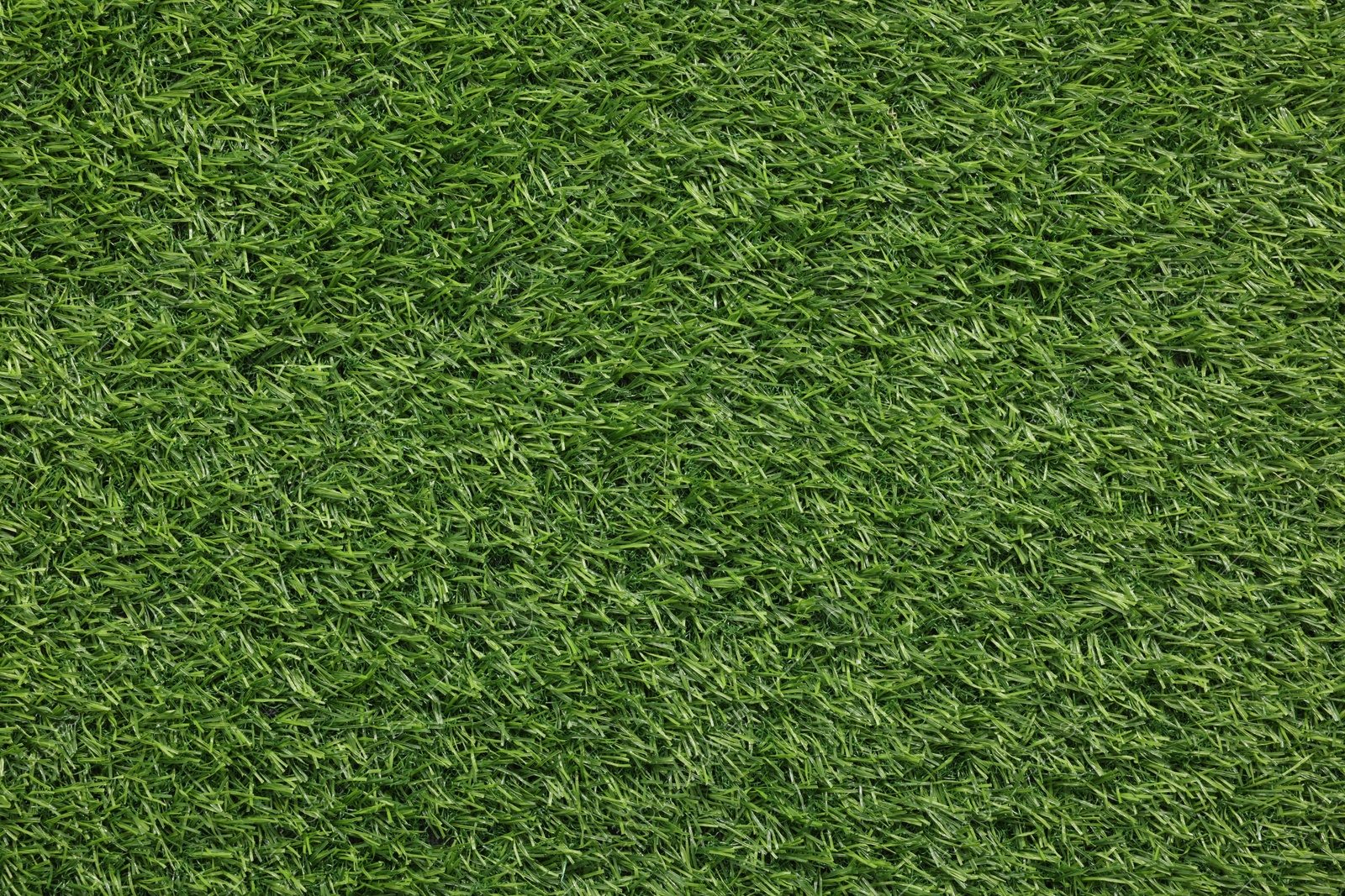 Photo of Green artificial grass as background, top view