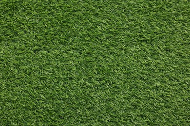 Photo of Green artificial grass as background, top view