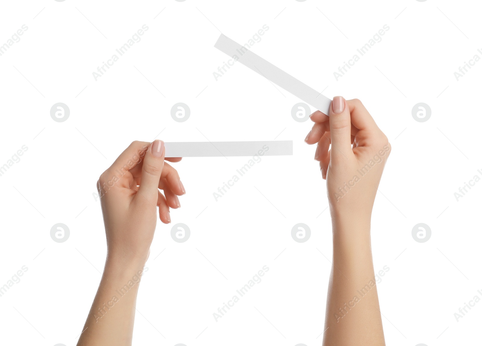 Photo of Woman holding perfume testing strips on white background, closeup of hands